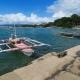 Pink Fishing Boat Docked in Local Village