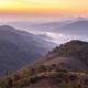 Mountain valleys in morning mist in Myanmar. Sunrise in mountains on Kalaw – Inle trek.