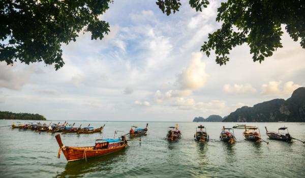 Longtail boats anchored at Maya Bay on Phi Phi Leh Island, Krabi Province, Thailand. It is part of Mu Ko Phi Phi National Park