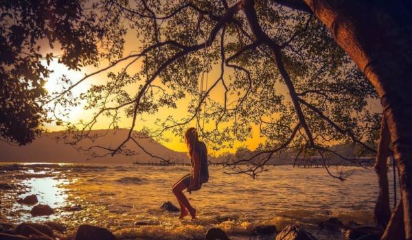 Woman relaxing on a swing on the beach , Koh Rong Samloem ,Cambo