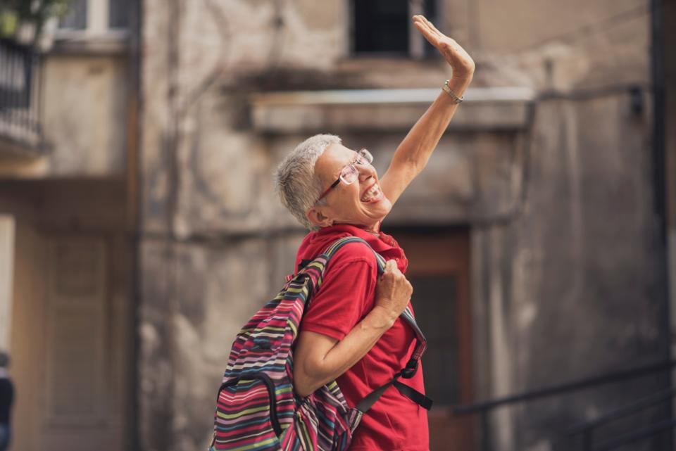 Senior lady traveling abroad, saying goodbye to home and family