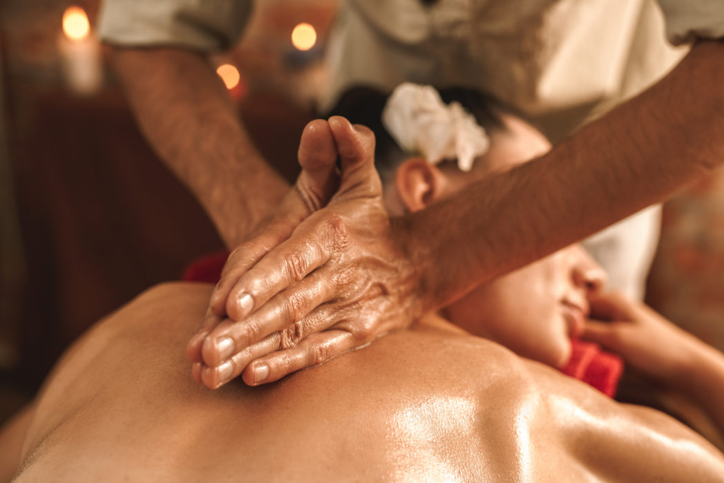 Alternative Medicine. Therapist healing woman doing ayurvedic massage with herbal oil close-up