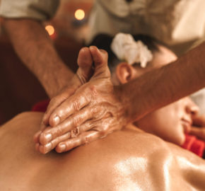 Alternative Medicine. Therapist healing woman doing ayurvedic massage with herbal oil close-up